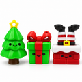 Christmas tree, gift box and Santa chimney fidget clickers shown together on a white background